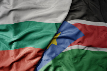 big waving national colorful flag of south sudan and national flag of bulgaria .