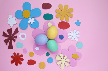 Easter decoration with colored eggs on pink background 