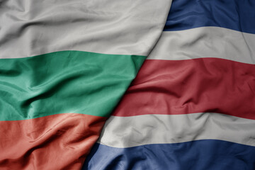 big waving national colorful flag of costa rica and national flag of bulgaria .