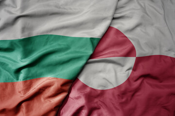 big waving national colorful flag of greenland and national flag of bulgaria .