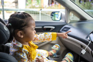 Little girl enjoying sit on car seat fasten belt - 740364791