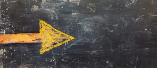 Vibrant yellow arrow painted on sleek black wall for directional signage