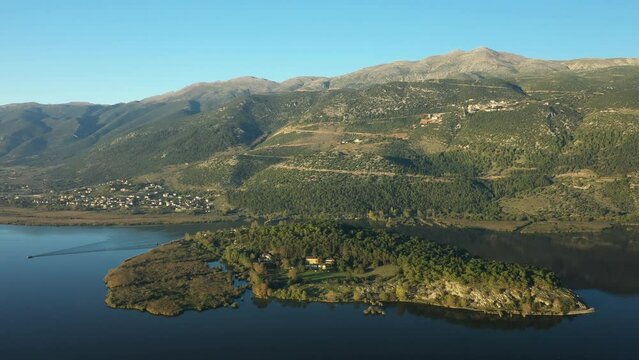 The island of Ioannina bordered by the lake in Europe, Greece, Epirus in summer on a sunny day.