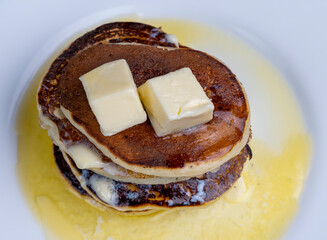 delicious cooked pancakes with cottage cheese and melted butter