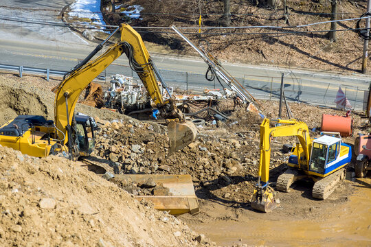 An excavator working on earthwork at industrial site under infrastructure development
