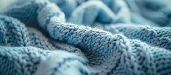 Close up of a cozy blue blanket with soft texture and knitted design for warmth and comfort at home