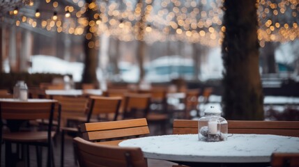 Fototapeta na wymiar Background in billboard design, outdoor table of restaurant in winter. Cozy atmosphere, focused focus, bokeh.