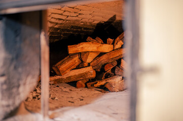 View of the Interior of an oven made with mud bricks, containing wood inside as fuel to cook bread.