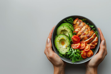 Woman's hands holding a bowl with salad with tomatoes, chicken, avocado, green leaves, top view of only hands with space for text or inscriptions, healthy eating theme.isolated.generative ai