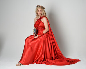 Full length portrait of beautiful blonde model dressed as ancient mythological fantasy goddess in...