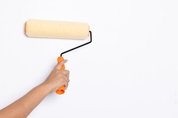 Decorator's hand painting wall with roller