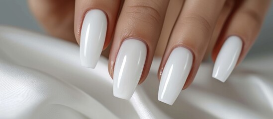 Elegant white nails on a female hand, showcasing beauty and style in a cosmetic concept