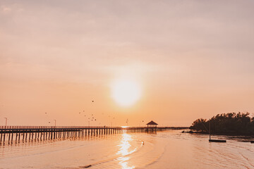 Sunset sea view seascape orange clear sky with long bridge.