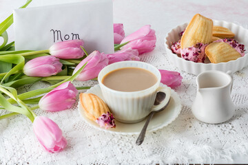 An elegant scene of tea served with decorated Madeleines for Mother's Day.