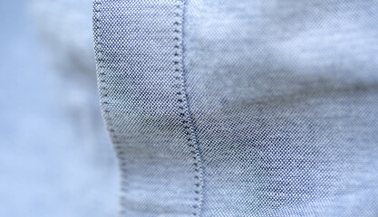 Close-up showing the fine texture and stitching of gray fabric of a quality shirt clothes and...