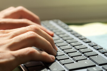 Close-up of a freelancers hands typing on a computer keyboard, productivity and digital online work modern office environment or home Blogging, writing, accounting desktop PC work job abstract concept
