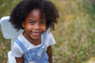 Portrait happy african american cute girl smiling face looking at camera at home, kid, child, young...
