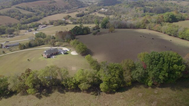 Aerial orbit over southeast USA, Tennesee rural landscape with fields and farms in early autumn