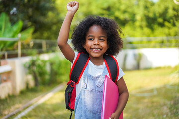 Back-to-school season with african american kid girl on the move with book and colorful school backpack, children, education, student go to school, study and learn at primary school