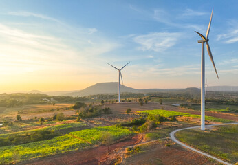 Wind farm field and sunset sky. Wind power. Sustainable, renewable energy. Wind turbines generate...