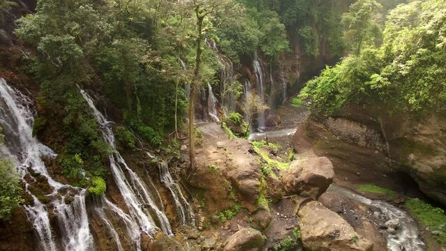 Hidden gem Waterfall with hundreds streamline in East Java Indonesia, aerial 4k drone footage