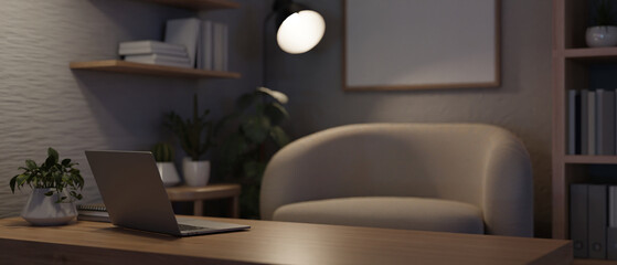 A laptop computer on a wooden coffee table in a modern cozy living room or home office at night.