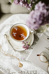 cup of tea with lilacs 