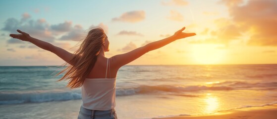 Fototapeta na wymiar Backlit Portrait of calm happy smiling free woman with open arms and closed eyes enjoys a beautiful moment life on the seashore at sunset 