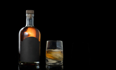 Black Background Whiskey bottle, black label, glass of whiskey