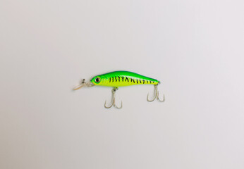 Green diving artificial fishing lure with white background.