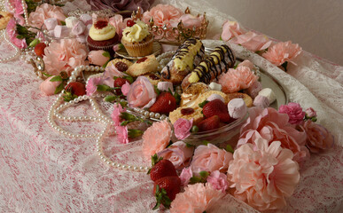 close up portraits of an indulgent feast of cakes, pastries and pink lollies wit rich jewels and...