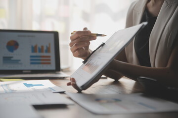 Close up of Business team analyzing income charts and graphs with modern laptop computer. Business analysis and strategy concept.