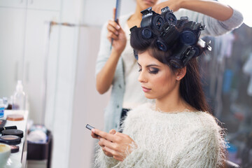 Model, woman and phone with hairdresser for beauty, hair stylist and behind the scenes with social...