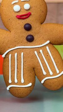 Festive Christmas food with gingerbread men, fruit cake and shortbread cookies, and reindeer ornaments centrepiece with blinking fairy lights background, close up dolly shot. . High quality