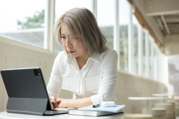Business woman using tablet on desk