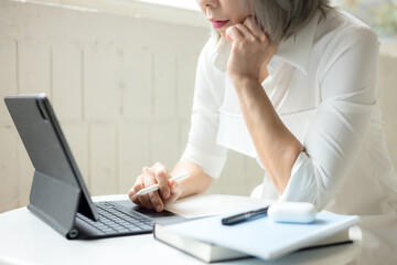 Business woman using tablet on desk
