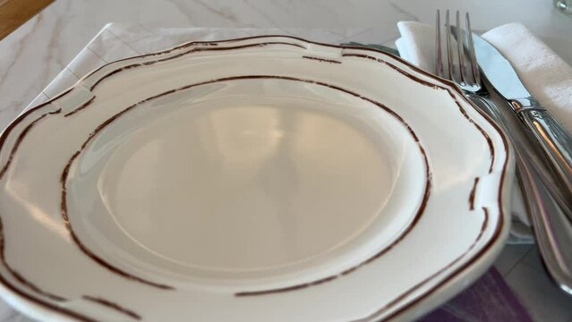 empty plate restaurant fork, knife and a circle shape plate on table . High quality 4k footage