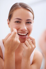 Portrait, mouth and dental floss for oral hygiene care with woman in bathroom of home for teeth...