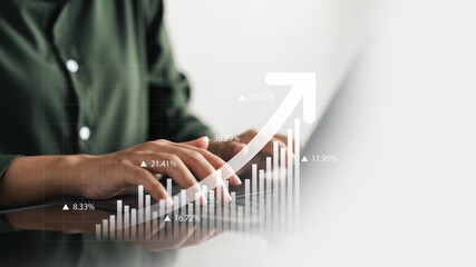 Businesswoman using tablet and laptop analyzing business growth graph data and progress, compass of...