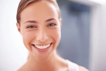 Gardinen Skincare, happy and portrait of woman in bathroom with cosmetic, health and wellness treatment. Beauty, confident and young female person with natural facial dermatology routine for glow at apartment © peopleimages.com