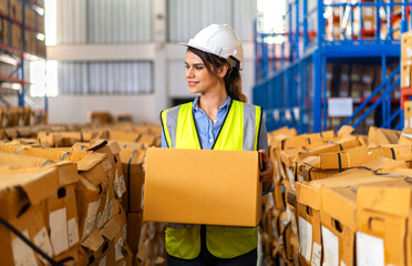 Portrait engineer woman shipping order detail check goods and supplies on shelves with goods...