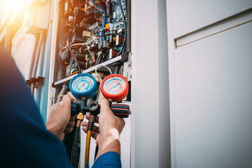 Technician is checking air conditioner refrigerant leak.