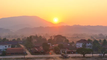 Fotobehang 19022024 Colorful hot air balloons fly over the Vang vieng city, Laos in Asia. This was during sunrise on a clear hot day during dry season. © Scotts Travel Photos