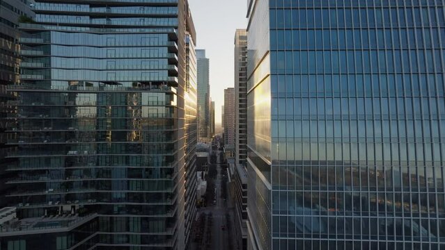Aerial shot of tall skyscraper glass office buildings in downtown district of Austin, Texas with cinematic light
