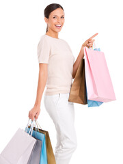 Pointing, shopping and portrait of woman on a white background with bag for sale, discount and deal news. Fashion, happy customer and isolated person for retail, consumerism and purchase in studio