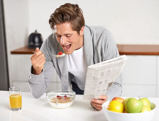 Cereal, juice and man with newspaper in kitchen for information at modern apartment. Nutrition,...