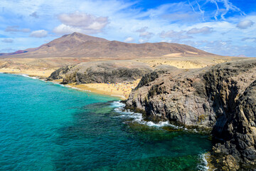 Fototapeta na wymiar Lanzarote island landscape with blue sky and sand beaches