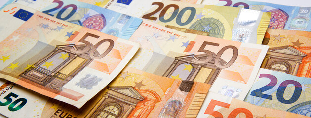 euro currency banknotes of different denominations on the table - obrazy, fototapety, plakaty