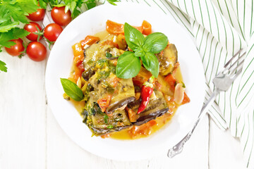 Rolls of eggplant with mincemeat in plate on board top