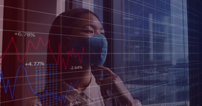 Image of financial data processing over asian businesswoman with face mask in office